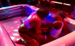 Women stripping one another oil wrestling