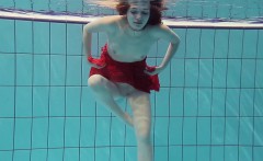 Red Dressed teen swimming with her eyes opened