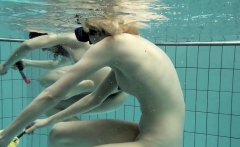 Girls swimming underwater and enjoying eachother